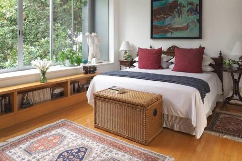 a bedroom with a large bed with red pillows at Casa Tabasco By The Local Way in Mexico City