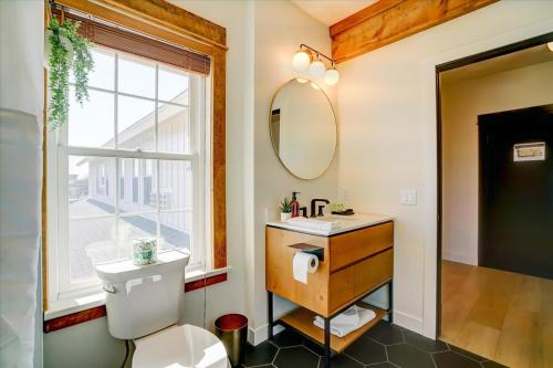 a bathroom with a toilet and a sink and a window at 206 - King Suite in Waunakee