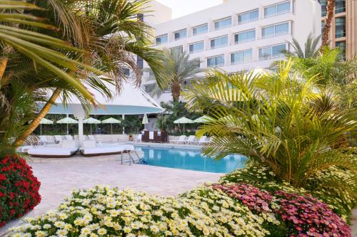 a resort with a swimming pool and a building at Lagoona by Isrotel Collection in Eilat