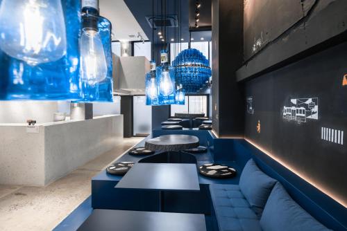 a row of tables in a restaurant with blue lights at Speck Bangkok in Bangkok