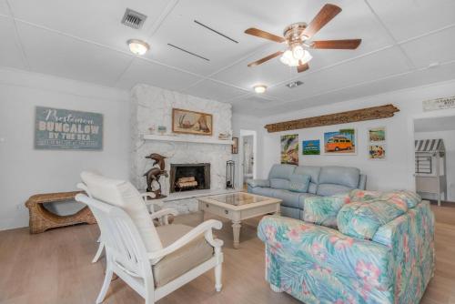 a living room with a couch and a fireplace at Bungalow By the Sea-Mermaid in Navarre
