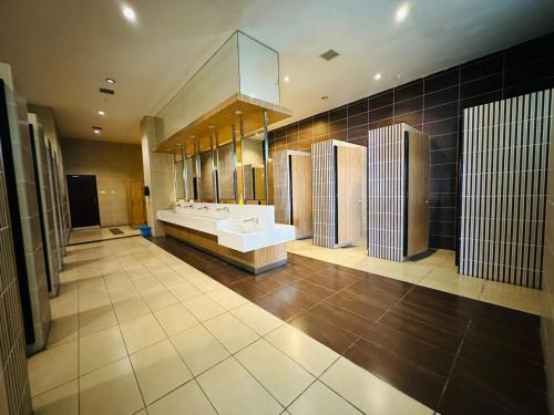 a large bathroom with two sinks and a large mirror at Paragon Residence 8-12pax-Big Balcony with BBQ in Johor Bahru