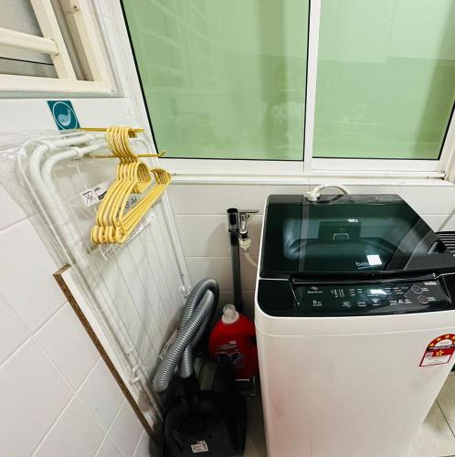 a washing machine in a room with a window at Paragon Residence 8-12pax-Big Balcony with BBQ in Johor Bahru