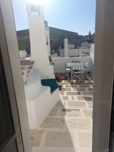 a view of a balcony with a table and chairs at Dimora Lavinia Casa vacanze Centro storico Ostuni in Ostuni