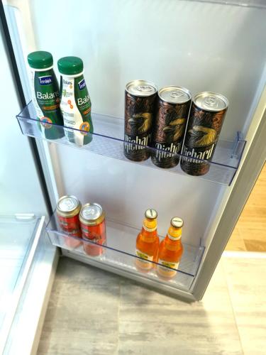 a refrigerator filled with lots of drinks and sodas at Ping in Lukavica