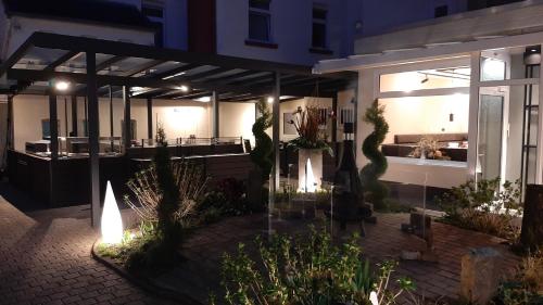 a house with a courtyard with plants and lights at Hotel Krupp in Bad Neuenahr-Ahrweiler