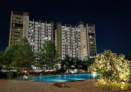 a large apartment building with a swimming pool at night at Budget price condo near IT Park & Ayala, Cebu City in Cebu City