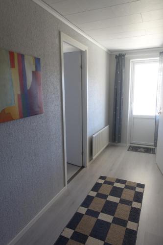 an empty room with a door and a rug at Views of Isaberg and fitting two families! in Hestra