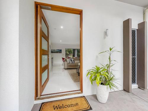 a doorway with a mirror and a plant in a room at Casa Mia Retreat Luxury Family Home on Buderim in Buderim