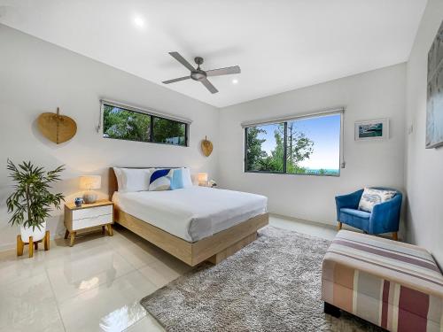 a bedroom with a bed and a ceiling fan at Casa Mia Retreat Luxury Family Home on Buderim in Buderim