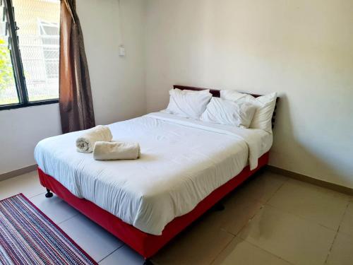 a bedroom with a large bed with white sheets and pillows at Masters 2 Bedroom Apartment Westfield in Nadi