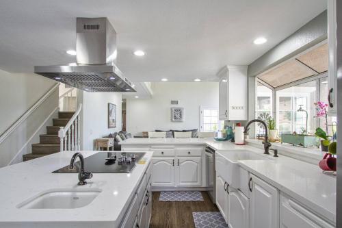 a kitchen with white cabinets and a sink at Casa Rosé in Temecula