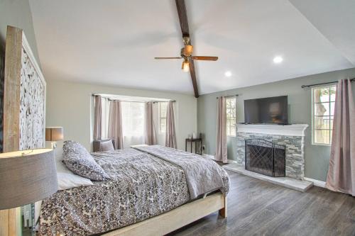 a bedroom with a bed and a fireplace and a ceiling fan at Casa Rosé in Temecula