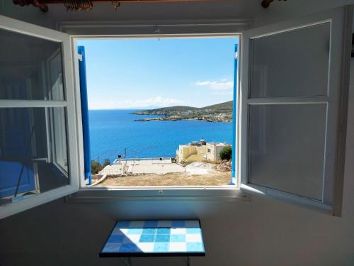 an open window with a view of the ocean at Aigaio View Studios & Rooms in Azolimnos