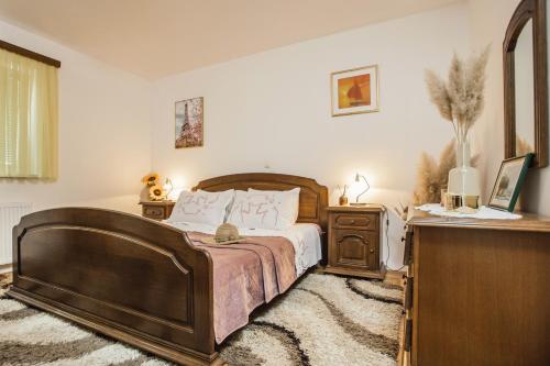 um quarto com uma grande cama de madeira e uma cómoda em Luxury Apartment Leonarda on the river Vrljika em Imotski