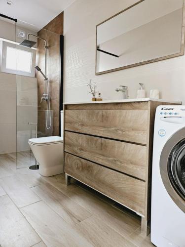 a bathroom with a sink and a washing machine at MIRADOR HOLIDAY HOME in Santa Pola