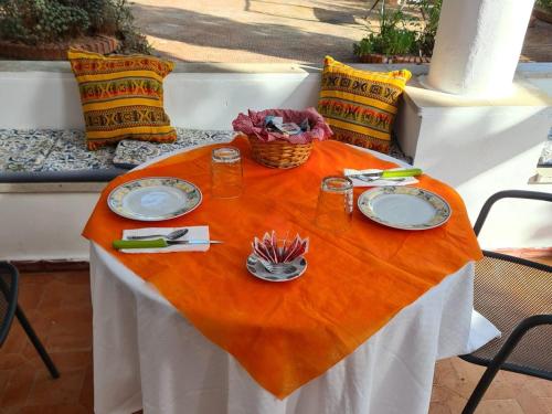 stół z dwoma talerzami i koszem na nim w obiekcie Villa il Glicine w mieście Vulcano