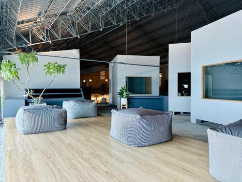 a room with three chairs and a large screen at KW2 Hostel in Kaohsiung