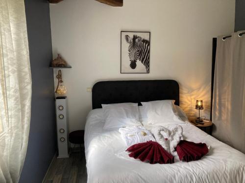 - une chambre dotée d'un lit avec une photo zébrée sur le mur dans l'établissement Gîte des Combes Blanches avec piscine et jacuzzi, à Frayssinet-le-Gélat