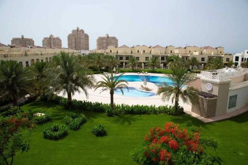 an aerial view of a resort with a swimming pool at Stunning high floor Ocean front Retreat with Panoramic Sea Views for Rent in Ras al Khaimah