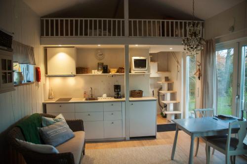 a kitchen and living room with a couch and a table at Strandboende in Beddinge Strand