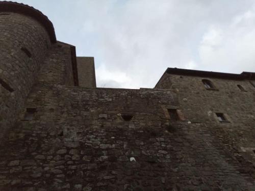 a tall brick building with a sky in the background at Convivio Etrusco in Bassano in Teverina