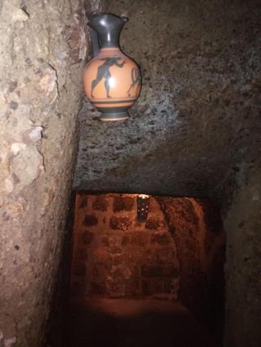 a vase sitting on top of a stone wall at Convivio Etrusco in Bassano in Teverina