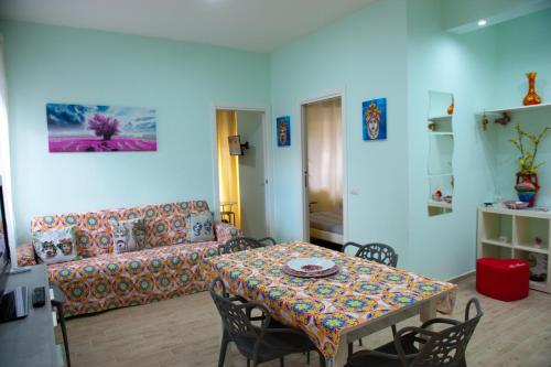 a living room with a table and a couch at I mori di Sicilia in Giardini Naxos