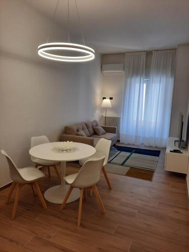 a living room with a table and chairs and a couch at APPARTAMENTO IL MARZOCCO in Pietrasanta