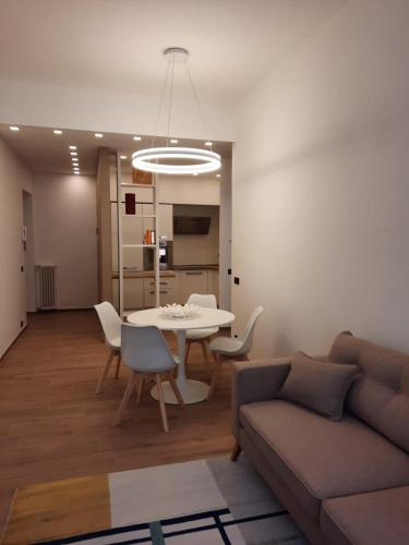 a living room with a couch and a table and chairs at APPARTAMENTO IL MARZOCCO in Pietrasanta