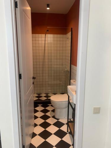 a bathroom with a toilet and a sink at Polifonia Inn Borjomi in Borjomi