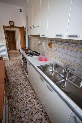 a kitchen with a sink and a stove at Casa Buonconte in Arezzo