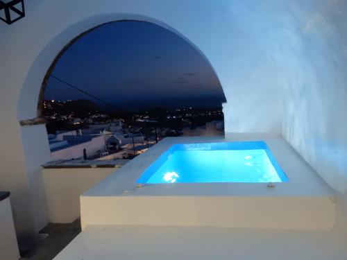 a swimming pool on the roof of a house at Pyrgos Cave Suites in Pirgos