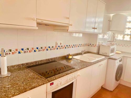 a kitchen with a sink and a counter top at Apartamento en primera línea de playa in Denia