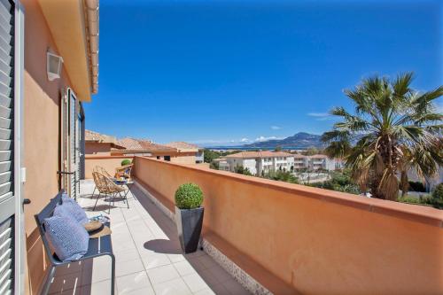 un balcon avec des chaises et une vue sur la ville dans l'établissement casa notte appart spacieux calme Plage et centre de calvi 15 min à pied, à Calvi
