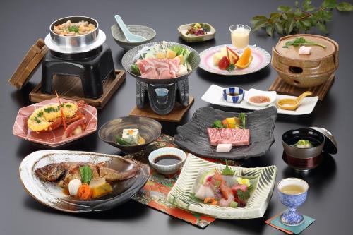 a table with many plates of food on it at Asagiriso in Toyooka