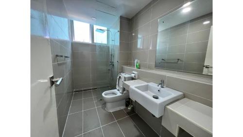 a bathroom with a sink and a toilet and a mirror at Sutera Avenue KK Infinity Pool 10 mins to Airport 10 mins to Jetty LSS HomeStay in Kota Kinabalu