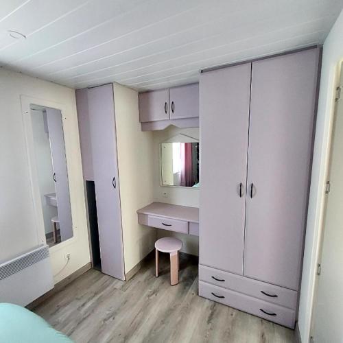 une chambre avec un bureau et une coiffeuse avec un miroir dans l'établissement Mammiehome - 6 places - Mimizan - Camping La Lande, à Mimizan