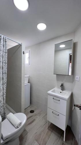 a white bathroom with a toilet and a sink at Salobre Blue Sky 3 in Salobre