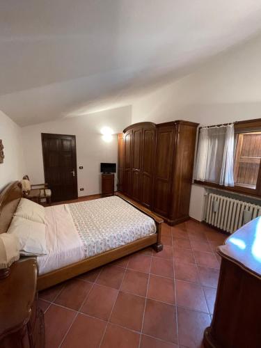 Schlafzimmer mit einem Bett und Holzschränken in einem Zimmer in der Unterkunft B&B San Biagio in Marola