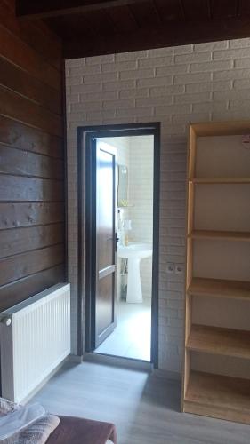 a door leading into a bathroom with a sink at Come & Rest in Stepantsminda