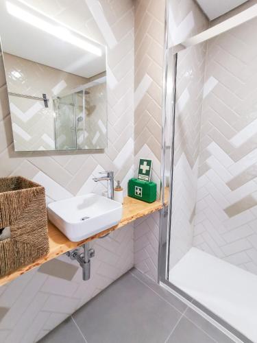 a bathroom with a sink and a shower at Costa D'Ouro in Castelo de Paiva