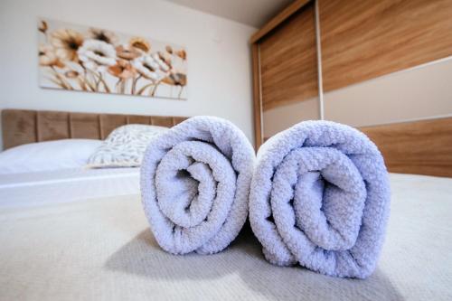 a pair of towel rings sitting on a bed at Roko Opaćac in Zadar