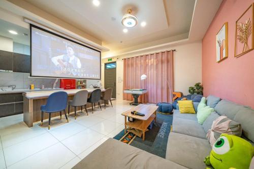 a living room with a couch and a large screen at SKYPIEA Villa 空島民宿 in Wujie