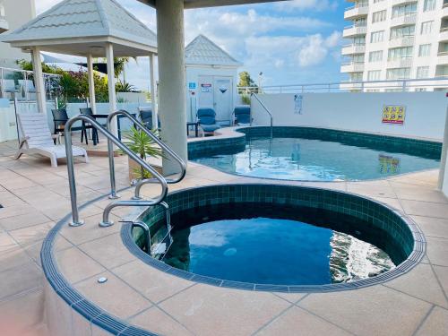 a swimming pool on top of a building at License To Chill • Couple’s Escape in Mooloolaba in Mooloolaba