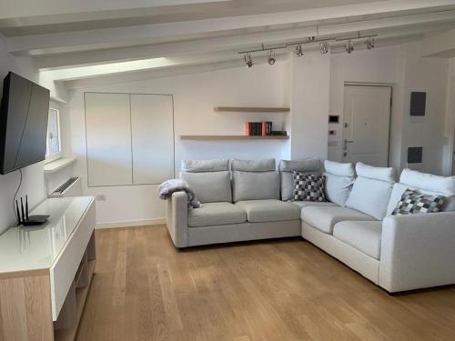 a living room with a couch and a television at cairoli7novate-mansarda in Novate Milanese