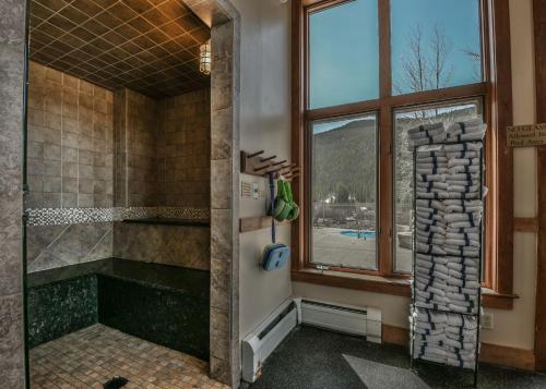 a bathroom with a walk in shower next to a window at Red Hawk Lodge 2269 in Keystone