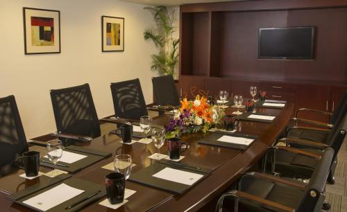 a conference room with a long table and chairs at Mysore County Retreat in Mysore