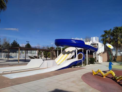 a slide in a park with a slide at Mobil-home Les Locs Danous in Valras-Plage