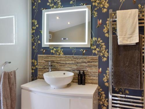 a bathroom with a sink and a mirror at Sandend in Lytham St Annes
